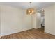 This dining room features wood floors, neutral walls, and a designer light fixture at 1364 Willis Mill Sw Rd, Atlanta, GA 30311