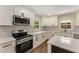 Bright kitchen with a white countertop, stainless steel oven, and hexagon backsplash tiles at 1364 Willis Mill Sw Rd, Atlanta, GA 30311