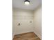 A bright laundry room features a wire shelf for storage and modern light fixture at 1364 Willis Mill Sw Rd, Atlanta, GA 30311