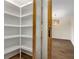 Walk-in pantry with wood-trimmed sliding glass door, wood floors, and floor to ceiling shelving at 1364 Willis Mill Sw Rd, Atlanta, GA 30311