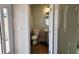 This home's powder room features a pedestal sink and a round mirror, offering functionality and classic style at 309 Melanie Ct, Bowdon, GA 30108