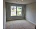 A bright bedroom featuring a large window with views of the neighborhood at 309 Melanie Ct, Bowdon, GA 30108