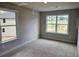 This bright bedroom features two large windows offering views of the neighborhood at 309 Melanie Ct, Bowdon, GA 30108