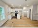 A spacious kitchen features white cabinets, stainless steel appliances, and an island, perfect for cooking and entertaining at 309 Melanie Ct, Bowdon, GA 30108