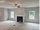 Living room with fireplace, windows and ceiling fan at 309 Melanie Ct, Bowdon, GA 30108