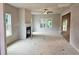 A spacious living room with a fireplace, ceiling fan, and windows creates a bright, inviting space at 309 Melanie Ct, Bowdon, GA 30108
