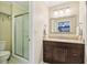 Cozy bathroom with a glass-door shower, vanity, and neutral color palette at 159 Cavan Se Way, Mableton, GA 30126