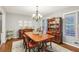 Traditional dining room with a wood table, china cabinet, chandelier, and a large window, perfect for Gathering gatherings at 159 Cavan Se Way, Mableton, GA 30126