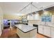 Open kitchen and dining area, featuring modern appliances, island, and hardwood flooring at 159 Cavan Se Way, Mableton, GA 30126