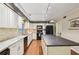 Bright kitchen featuring granite countertops, white cabinets, stainless steel appliances, island and hardwood floors at 159 Cavan Se Way, Mableton, GA 30126