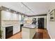 Modern kitchen features white cabinetry, granite countertops, stainless steel appliances, and a functional kitchen island at 159 Cavan Se Way, Mableton, GA 30126