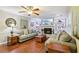 Inviting living room with fireplace, built-in shelving, hardwood floors, and abundant natural light at 159 Cavan Se Way, Mableton, GA 30126
