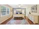 Bright main bedroom with hardwood floors, area rug, ceiling fan, and ensuite bathroom access at 159 Cavan Se Way, Mableton, GA 30126