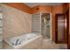 Elegant bathroom featuring a large soaking tub and glass-enclosed shower with tile surround at 3334 Peachtree Ne Rd # 1707, Atlanta, GA 30326
