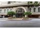 Attractive building entrance with an arched doorway, elegant landscaping, and well-maintained curb appeal at 3334 Peachtree Ne Rd # 1707, Atlanta, GA 30326