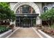 Elegant building entrance with manicured landscaping and an arched entryway at 3334 Peachtree Ne Rd # 1707, Atlanta, GA 30326