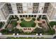 Aerial view of a courtyard featuring manicured lawns, gardens, and seating areas at 3334 Peachtree Ne Rd # 1707, Atlanta, GA 30326