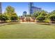 Lush green space surrounded by trees, offering seating with city views at 3334 Peachtree Ne Rd # 1707, Atlanta, GA 30326