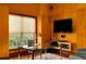 Wood paneled home office with a desk, large window, and TV, ideal for remote work at 3334 Peachtree Ne Rd # 1707, Atlanta, GA 30326
