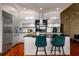 Contemporary kitchen with white cabinetry, stainless appliances, black countertop, and hardwood floors at 3334 Peachtree Ne Rd # 1707, Atlanta, GA 30326