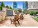 Serene outdoor seating area with a charming water feature and comfortable wooden chairs in an upscale building at 3334 Peachtree Ne Rd # 1707, Atlanta, GA 30326