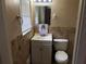Bathroom featuring a single vanity and a tiled wall at 4485 Merlin Ne Cir, Douglasville, GA 30134