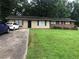 Charming single-story home with a well-maintained lawn and mature trees at 4485 Merlin Ne Cir, Douglasville, GA 30134