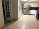 Functional kitchen with tiled floor, stainless steel refrigerator and a doorway entrance at 4485 Merlin Ne Cir, Douglasville, GA 30134