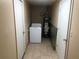 Laundry room features tile flooring, washer, and hot water tank at 4485 Merlin Ne Cir, Douglasville, GA 30134
