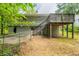 Exterior view of home with a wooden deck and stairs leading to the backyard at 4669 Birch Ridge Trl, Stone Mountain, GA 30083