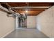 Unfinished basement with concrete floors, white brick walls, and exposed wooden ceiling joists at 4669 Birch Ridge Trl, Stone Mountain, GA 30083