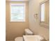Bathroom featuring modern fixtures, including a sink, toilet, and window at 4669 Birch Ridge Trl, Stone Mountain, GA 30083