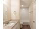 Bright bathroom features a granite vanity, toilet and tub with white tile surround at 4669 Birch Ridge Trl, Stone Mountain, GA 30083