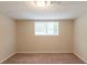 Cozy bedroom featuring neutral walls, carpeted floor, and natural light from a window at 4669 Birch Ridge Trl, Stone Mountain, GA 30083