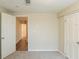 Bedroom featuring neutral walls, carpeted floor, and two doors: one open to another room at 4669 Birch Ridge Trl, Stone Mountain, GA 30083
