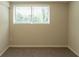 Bright bedroom with neutral walls, carpeted flooring, and a window with backyard views at 4669 Birch Ridge Trl, Stone Mountain, GA 30083