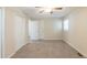 Bedroom features a ceiling fan, closet, neutral paint, and carpet flooring at 4669 Birch Ridge Trl, Stone Mountain, GA 30083