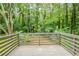 Wooden deck with wooded view and gray railing at 4669 Birch Ridge Trl, Stone Mountain, GA 30083