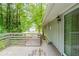 Spacious wooden deck with wooded views and side of house visible through a sliding door at 4669 Birch Ridge Trl, Stone Mountain, GA 30083