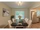 Elegant dining room with a black marble table, seating for eight, and stainless steel appliances in the kitchen at 4669 Birch Ridge Trl, Stone Mountain, GA 30083