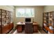 Functional home office with a large desk, comfortable chair, built-in shelving, and natural light at 4669 Birch Ridge Trl, Stone Mountain, GA 30083