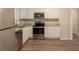 Modern kitchen with white cabinets, granite countertops, stainless steel appliances, and wood flooring at 4669 Birch Ridge Trl, Stone Mountain, GA 30083