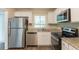 Bright kitchen with stainless steel appliances, white cabinetry and stone countertops at 4669 Birch Ridge Trl, Stone Mountain, GA 30083