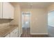 Kitchen area with granite countertops and a hallway view leading to the staircase at 4669 Birch Ridge Trl, Stone Mountain, GA 30083