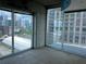 A carpeted bedroom is adjacent to an outdoor patio, providing an indoor-outdoor living experience at 361 17Th Nw St # 1303, Atlanta, GA 30363
