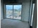Bedroom with large windows showcasing city views at 361 17Th Nw St # 1303, Atlanta, GA 30363