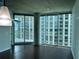 Living room features hardwood floors, floor to ceiling windows and an exposed ceiling at 361 17Th Nw St # 1303, Atlanta, GA 30363