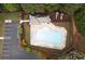 Aerial view of community pool and clubhouse, surrounded by trees and lounge chairs at 6435 Ivey Creek Cir, Cumming, GA 30040