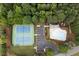 Aerial view of tennis courts, pool, cabana, parking, landscaping, and trees at 6435 Ivey Creek Cir, Cumming, GA 30040