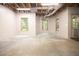 Unfinished basement area with concrete floor, natural light from windows, and exposed ceiling at 6435 Ivey Creek Cir, Cumming, GA 30040